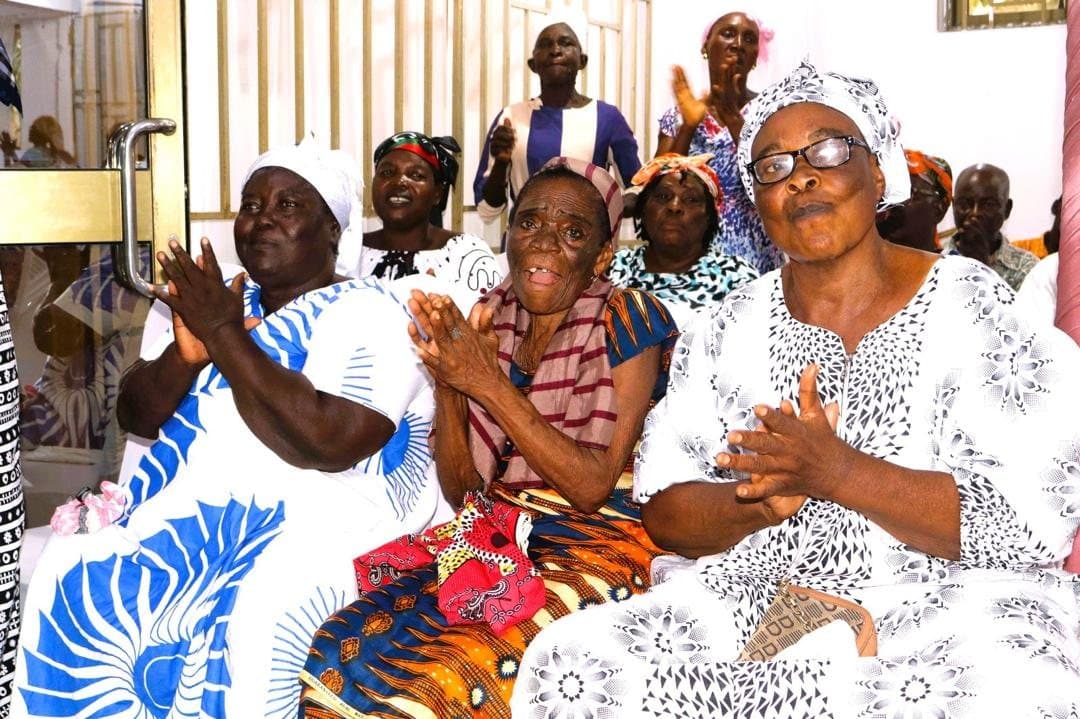 Elderly community members seated at a foundation support event