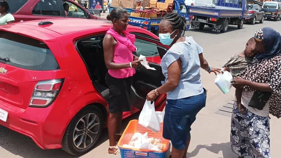 Volunteers unloading and distributing relief items outdoors